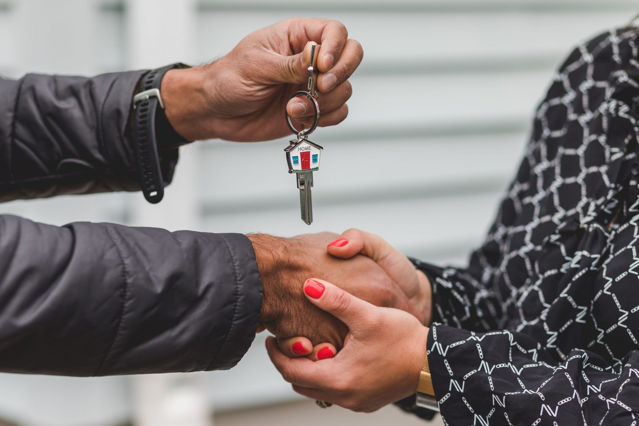 Handing over house keys in handshake